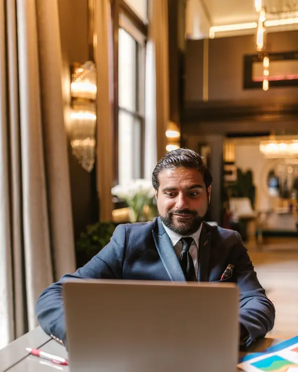 Business owner reviewing invoices on a laptop